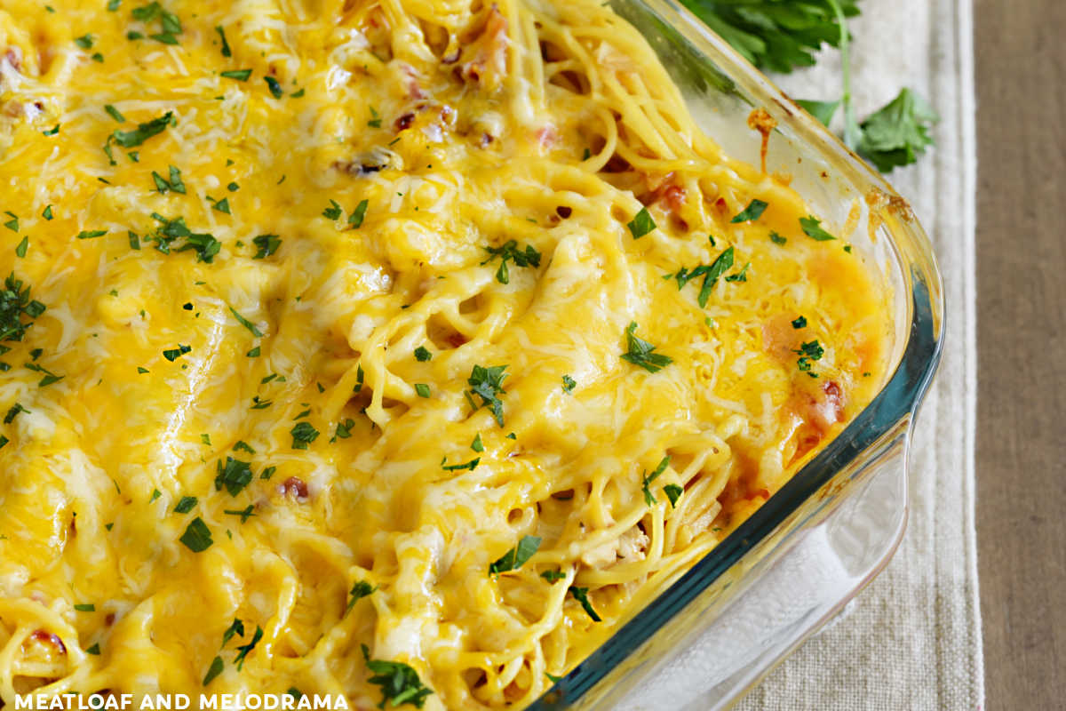 baked chicken spaghetti with parsley in baking dish