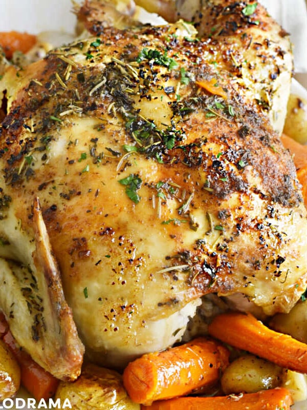 easy roast chicken with carrots and potatoes on a white platter