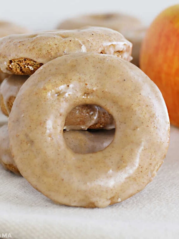glazed apple spice cake donut with apples on the table