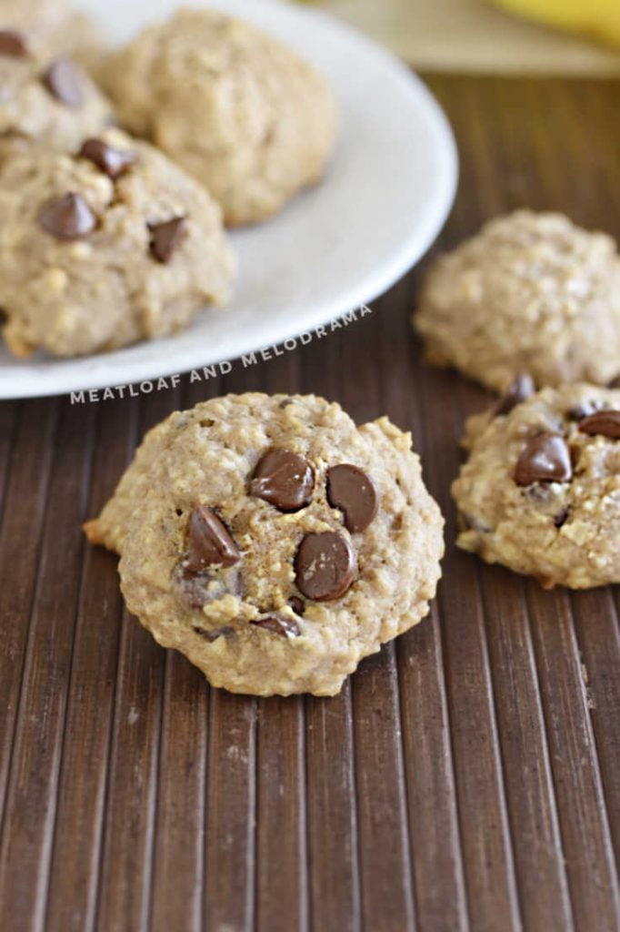 banana oatmeal cookies with chocolate chips on the table and on a white plate