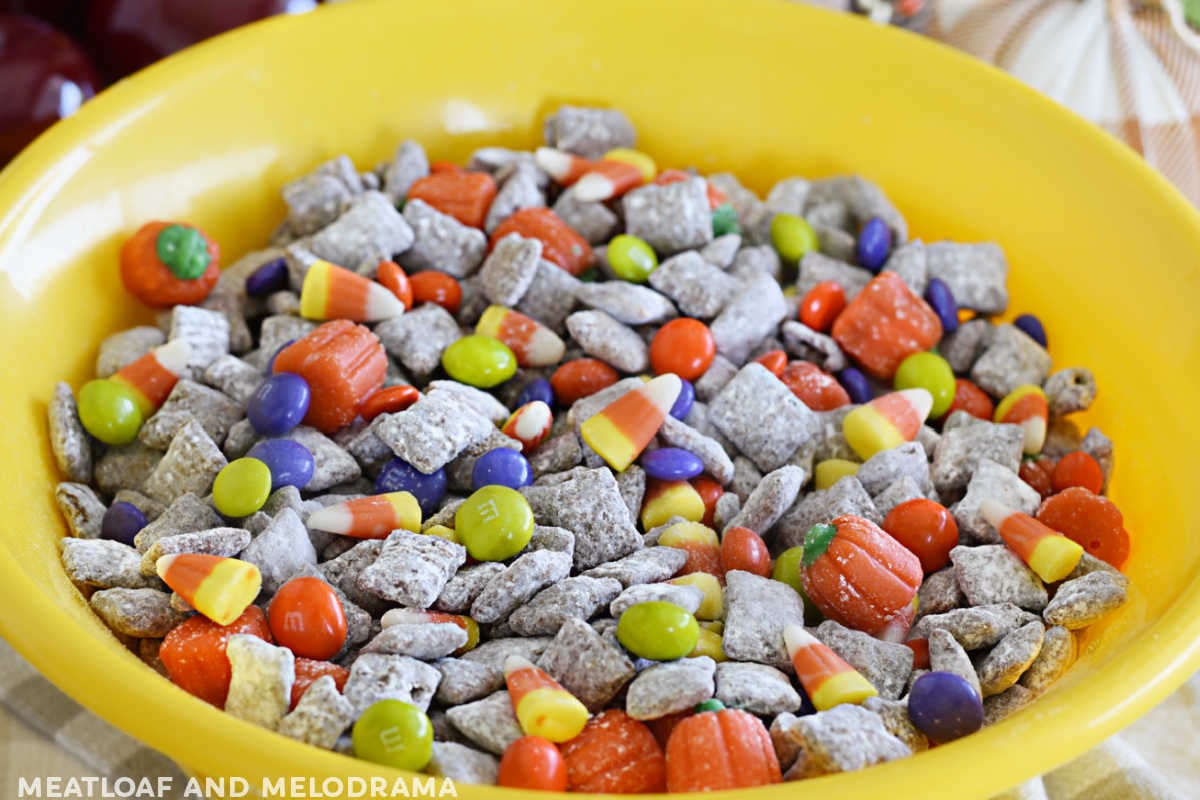 bowl of chex cereal puppy chow with fall and halloween candy