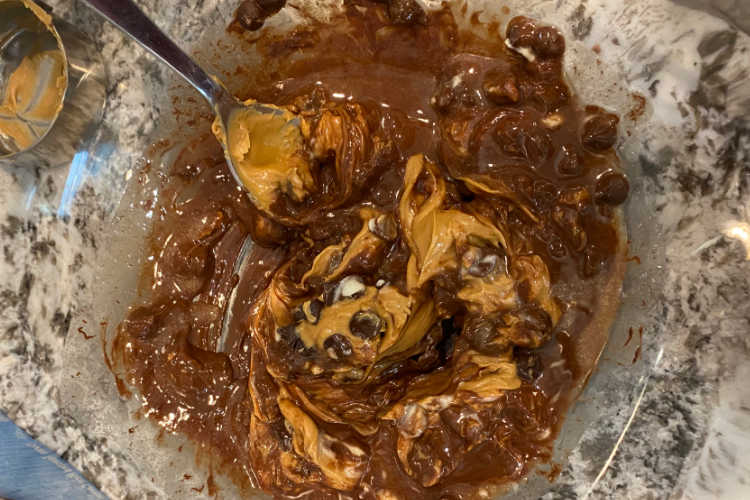 melted peanut butter and chocolate chips in a mixing bowl