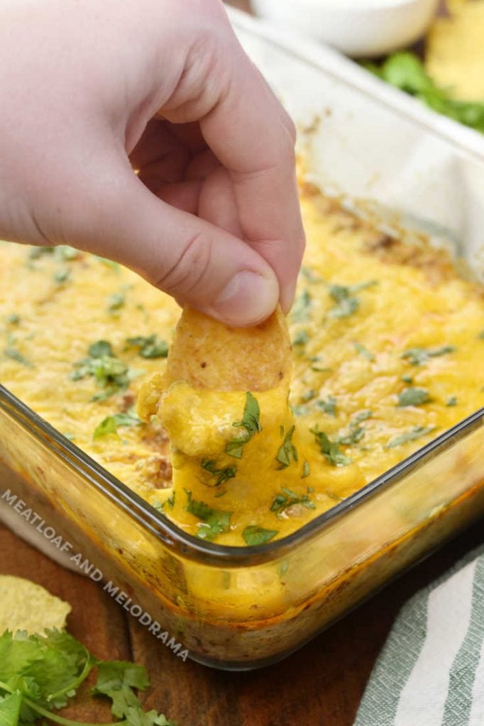 scoop cheesy taco dip up with frito corn chip