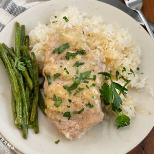 boneless crock pot pork chop on plate with green beans and rice