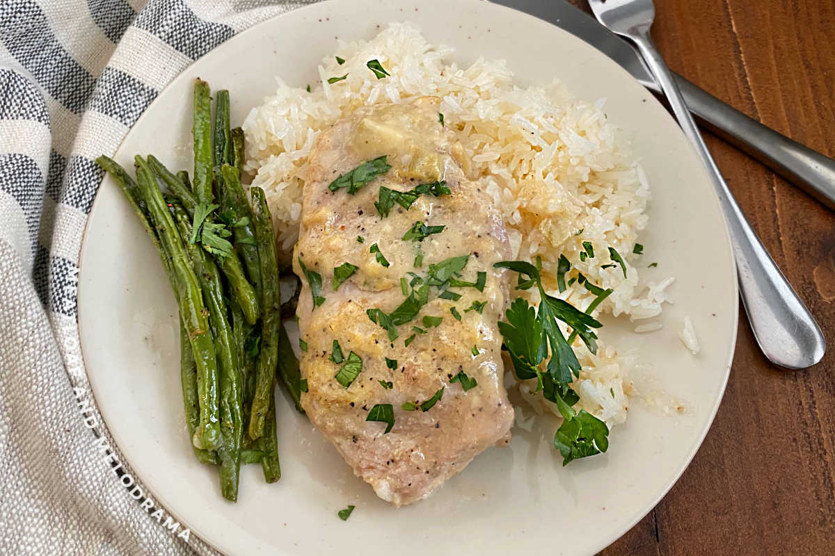 boneless crock pot pork chop on plate with green beans and rice