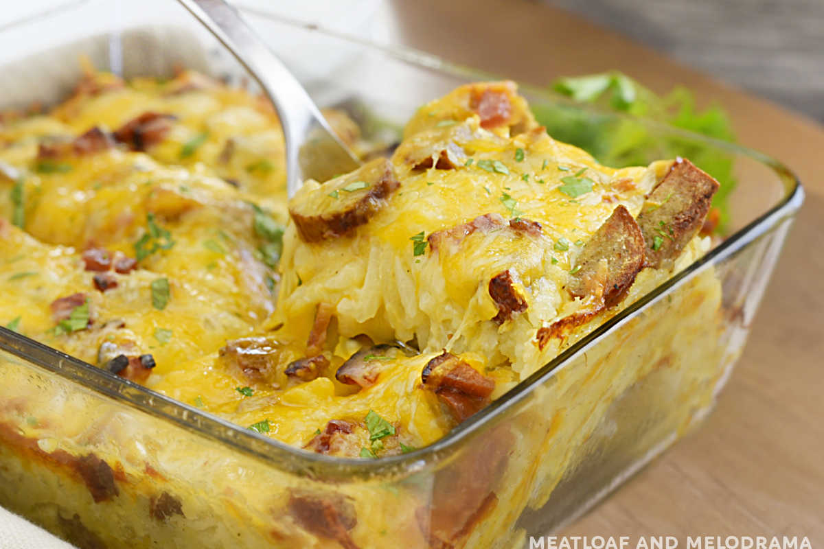 hashbrown breakfast casserole with sausage and cheese on a serving spoon