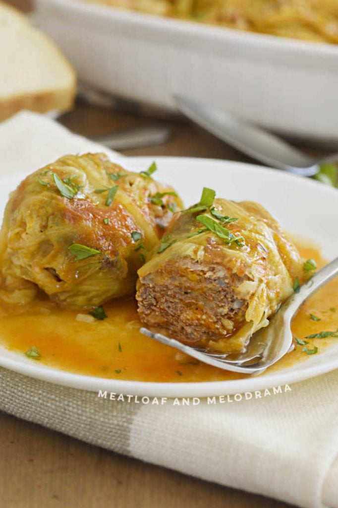 cut open cabbage rolls on a plate with fork