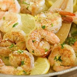 shrimp scampi with lemon and parsley in a skillet