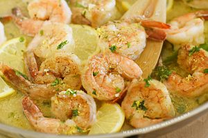 shrimp scampi with lemon and parsley in a skillet