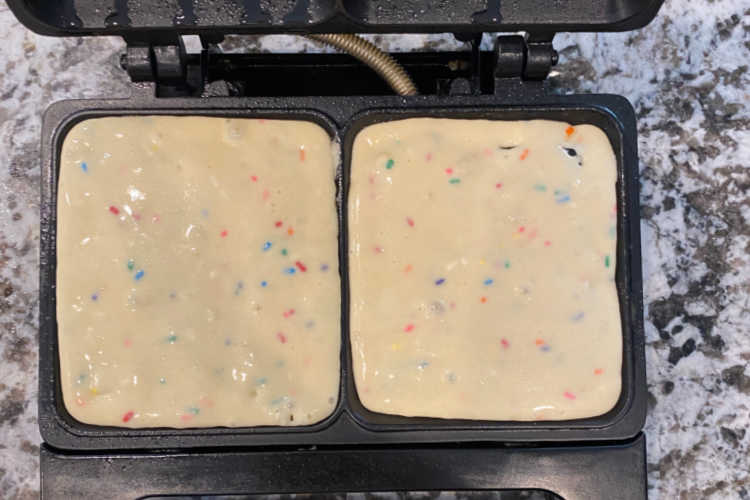 funfetti waffle batter in waffle iron