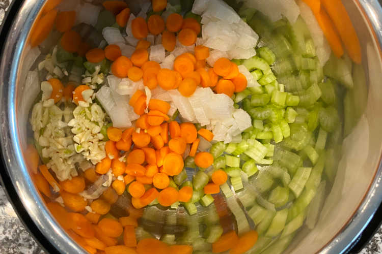 chopped carrots, onions, celery and garlic in the instant pot