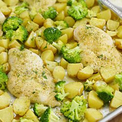 baked ranch chicken dinner with potatoes and broccoli on a sheet pan