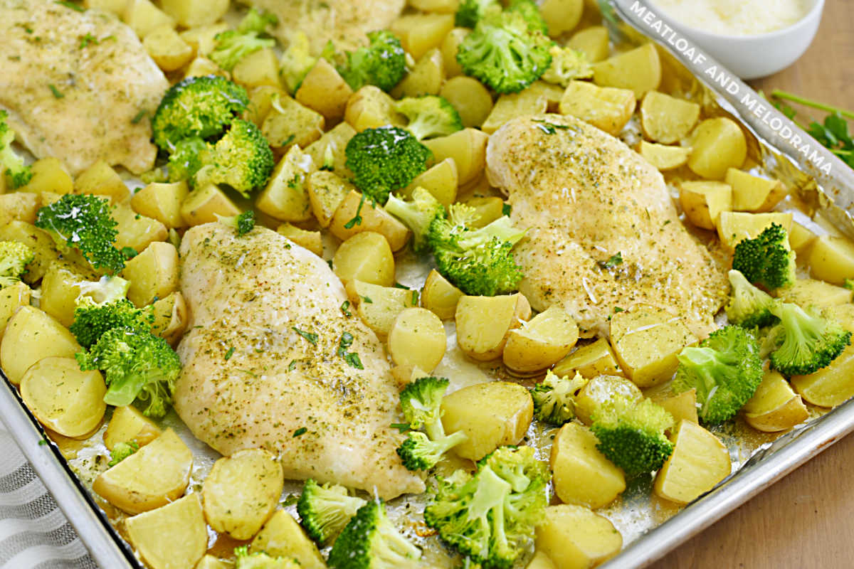 baked ranch chicken breasts with potatoes and broccoli on a sheet pan