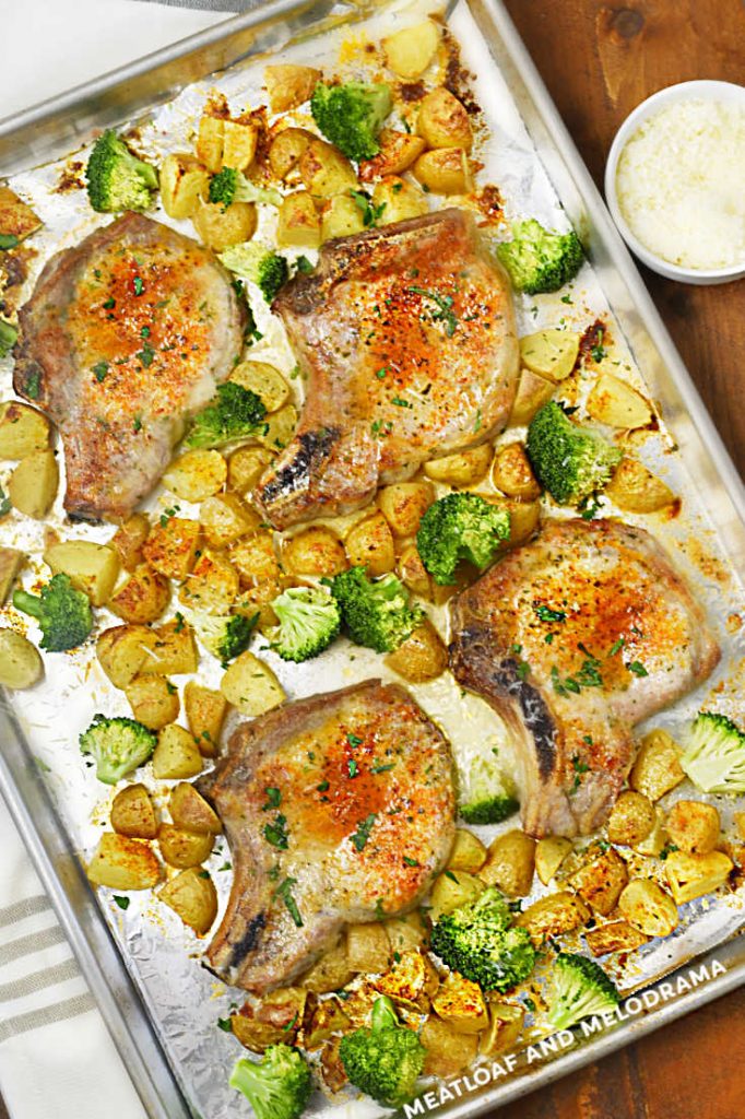 bone in pork chops with potatoes and broccoli on a sheet pan