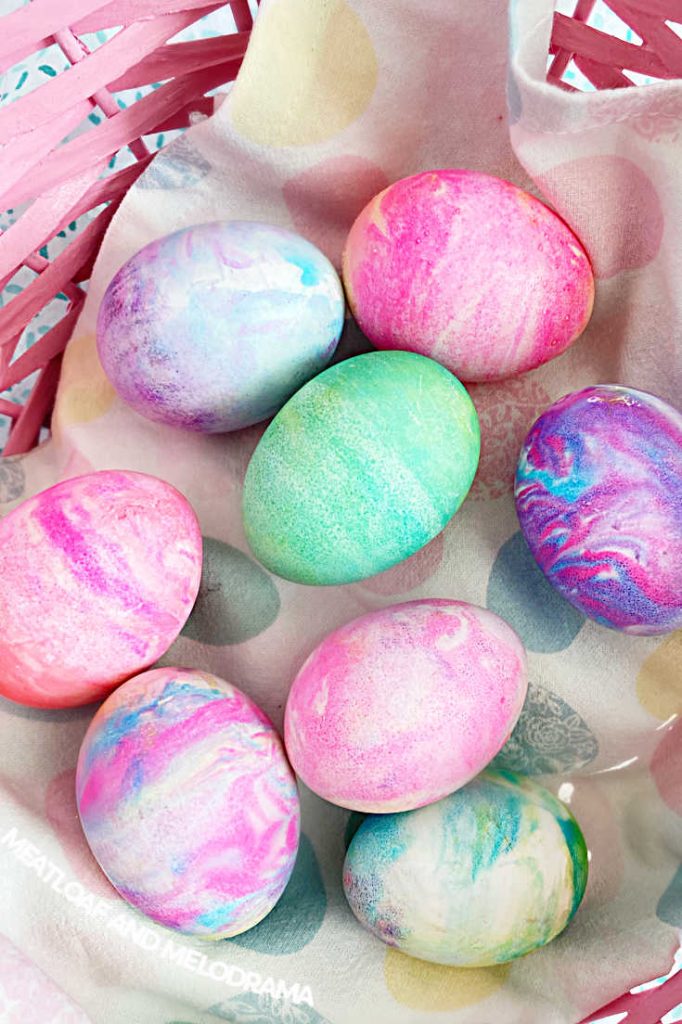Easter eggs dyed with cool whip in a pink easter basket