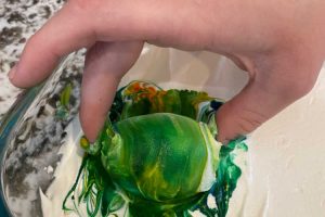 roll egg in cool whip and food coloring
