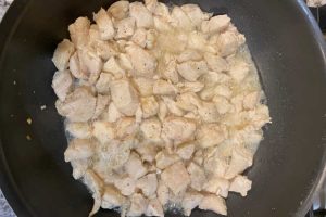 cubed chicken breasts in frying pan