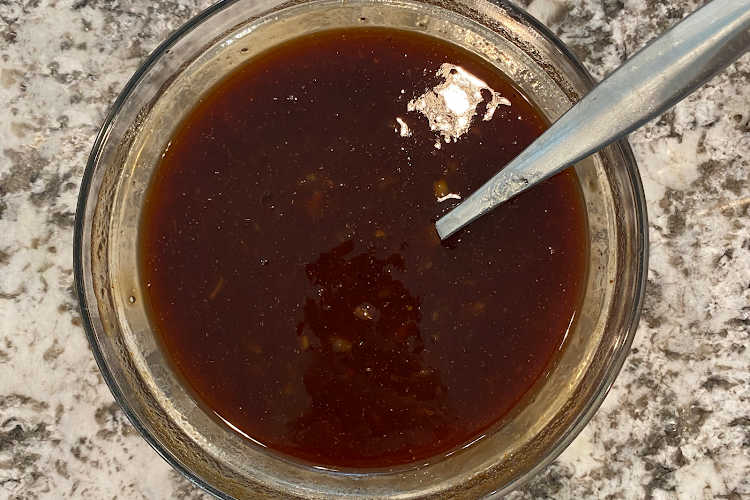 orange marmalade and BBQ sauce in a mixing bowl