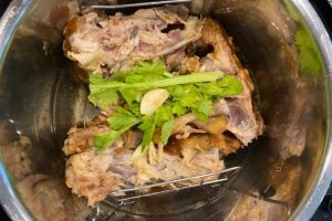 chicken carcass with garlic and celery in instant pot
