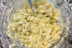 stir egg salad ingredients together in mixing bowl