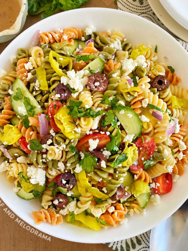 Greek pasta salad with feta cheese in white serving bowl