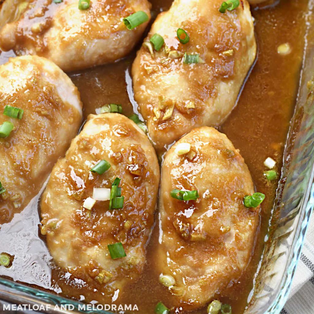 baked honey garlic chicken breasts with green onions in baking dish