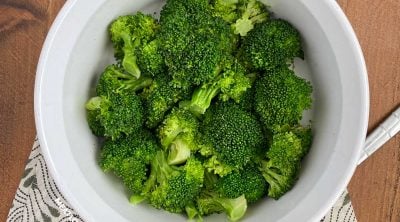 bowl of microwave broccoli with serving spoon