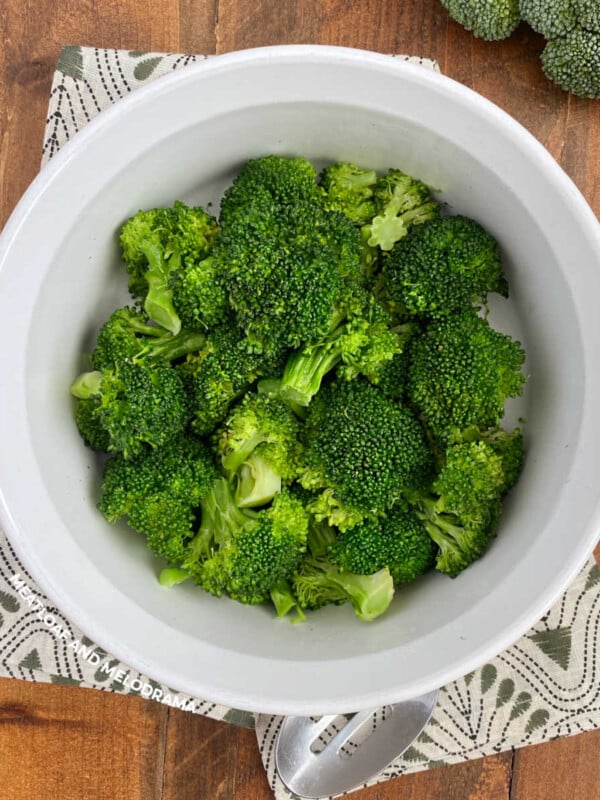 bowl of microwave broccoli with serving spoon