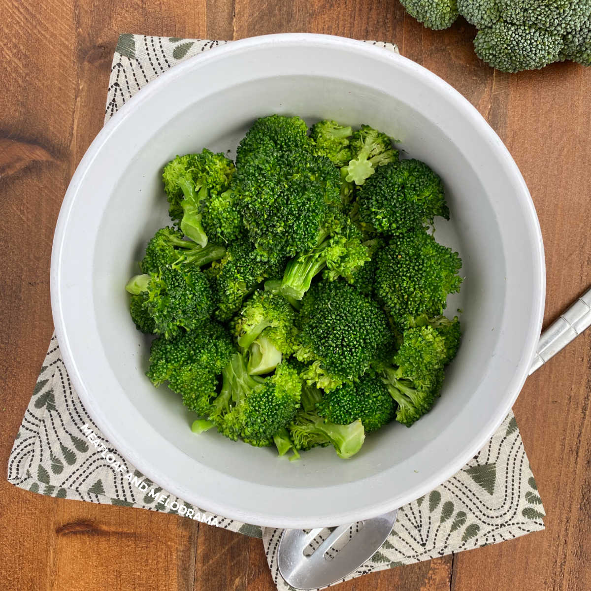 bowl of microwave broccoli with serving spoon