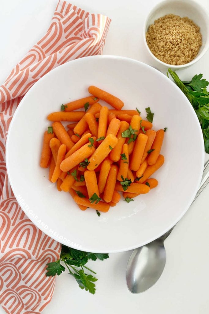 microwave carrots in white serving bowl with parsley