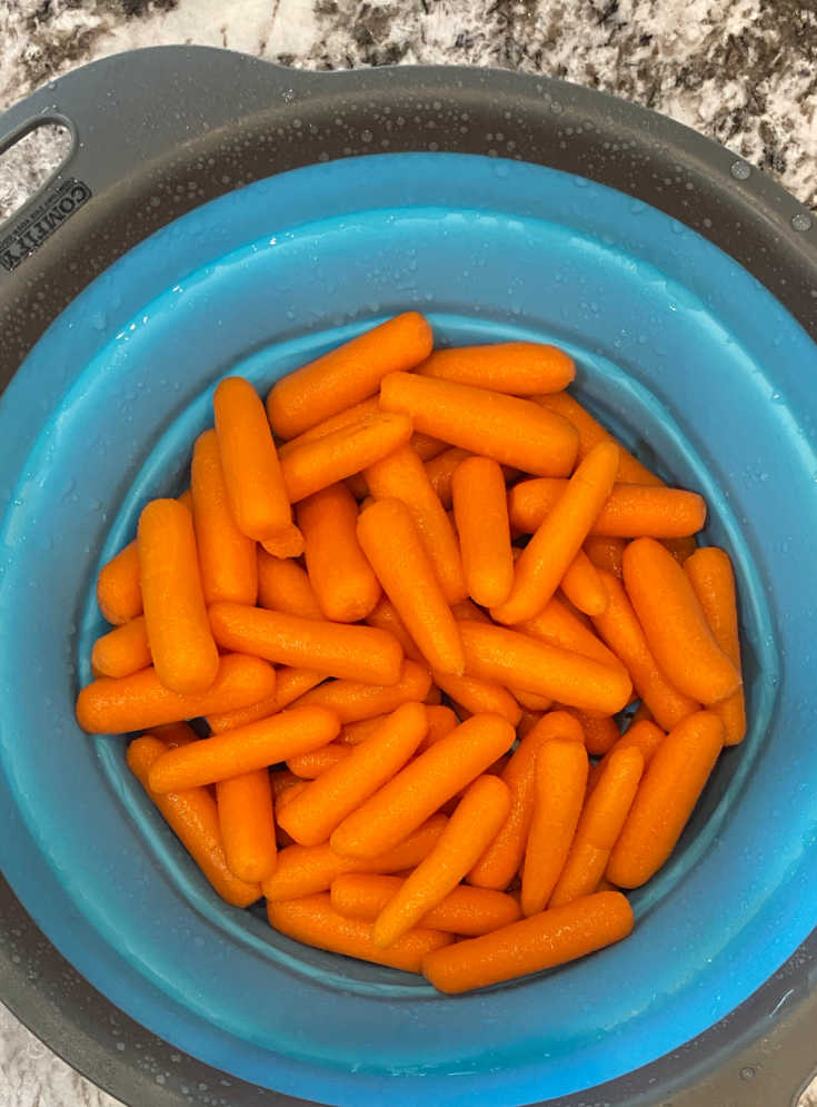 raw baby carrots in colander
