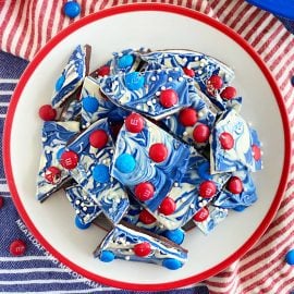 overhead pic of red white and blue bark with m and m candy on plate