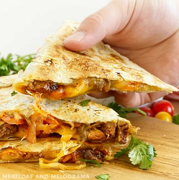 steak quesadilla with melted cheese in hand