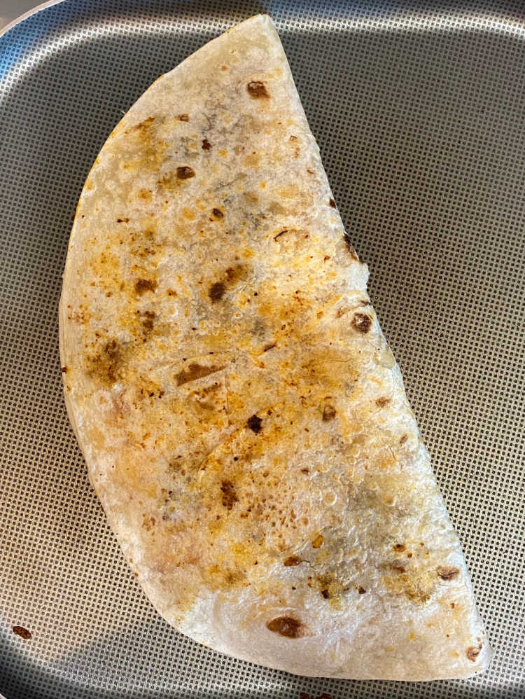folded quesadilla on a griddle pan