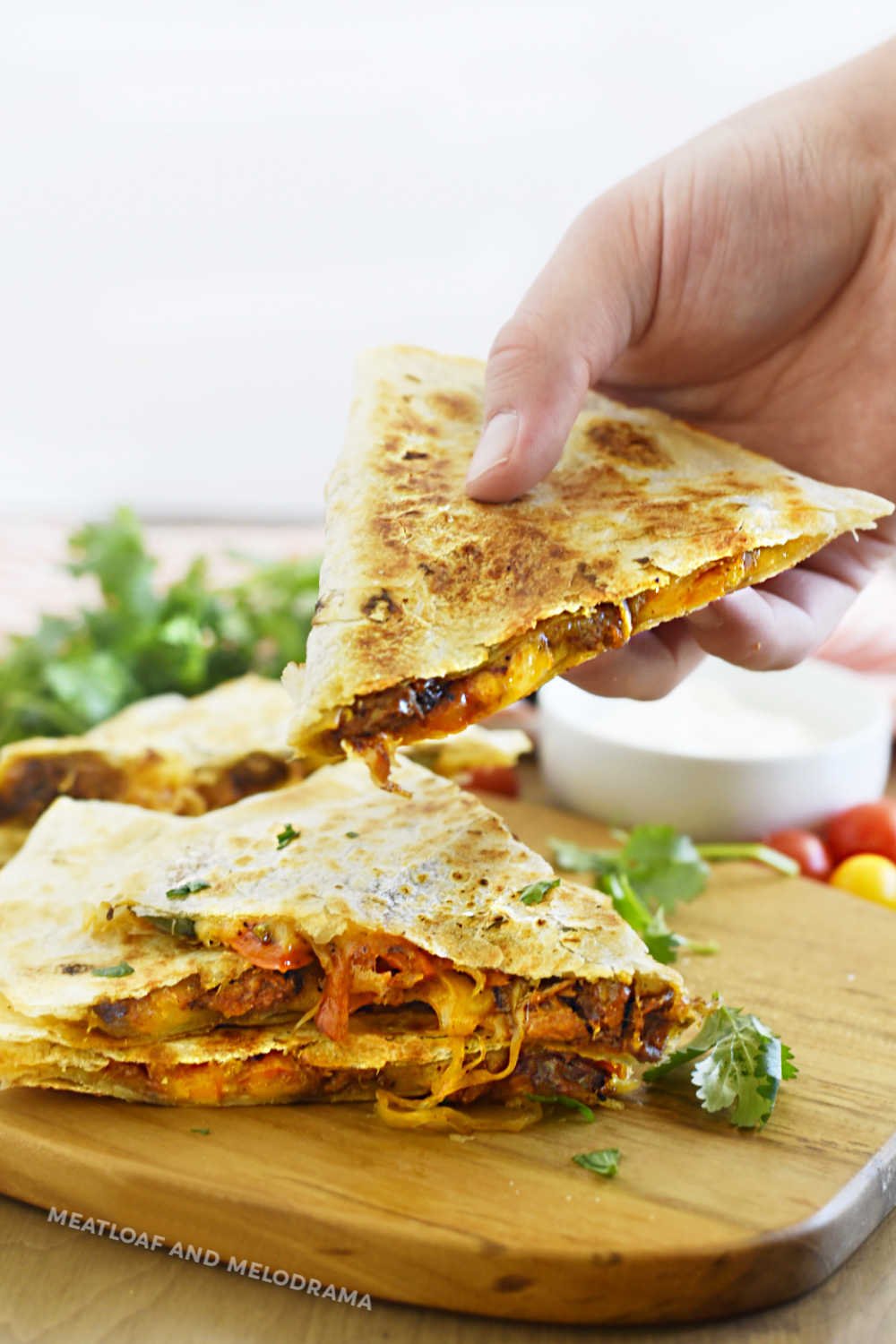 hand holding sliced steak quesadilla