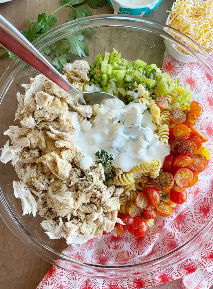 stir ranch dressing in pasta salad