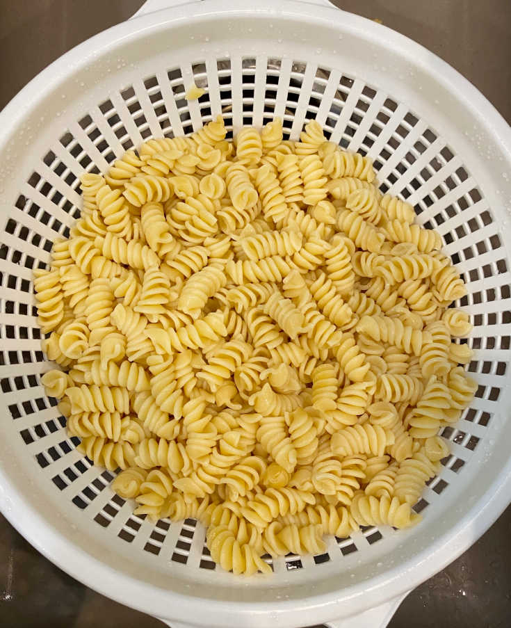 cooked rotini pasta in colander