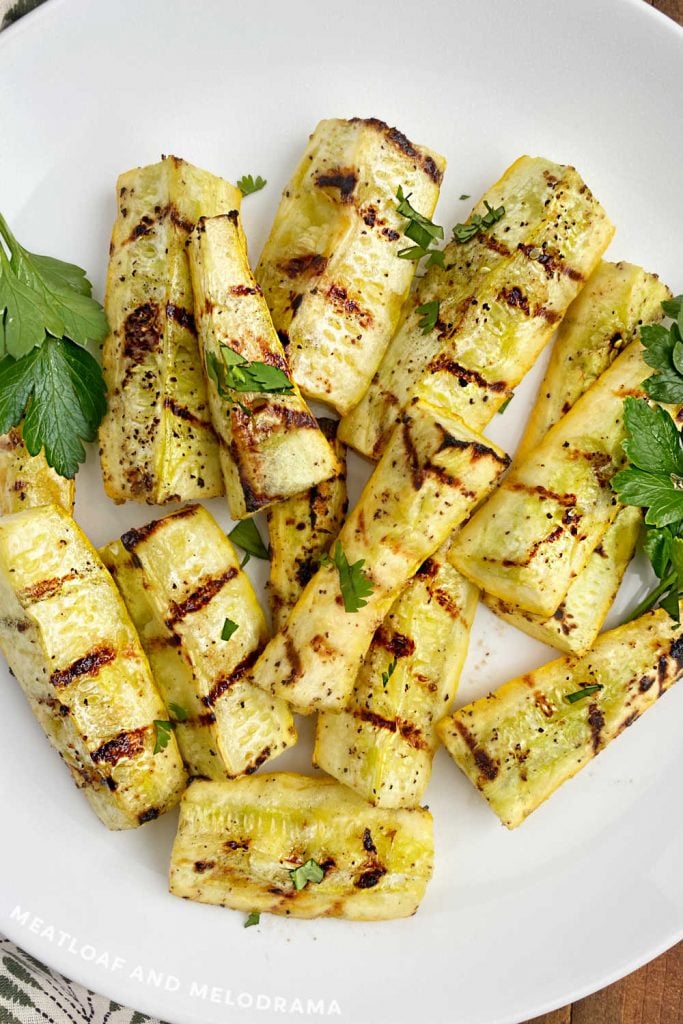 grilled summer squash close up on white platter