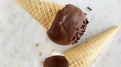 homemade drumsticks ice cream cones with chocolate coating on marble surface