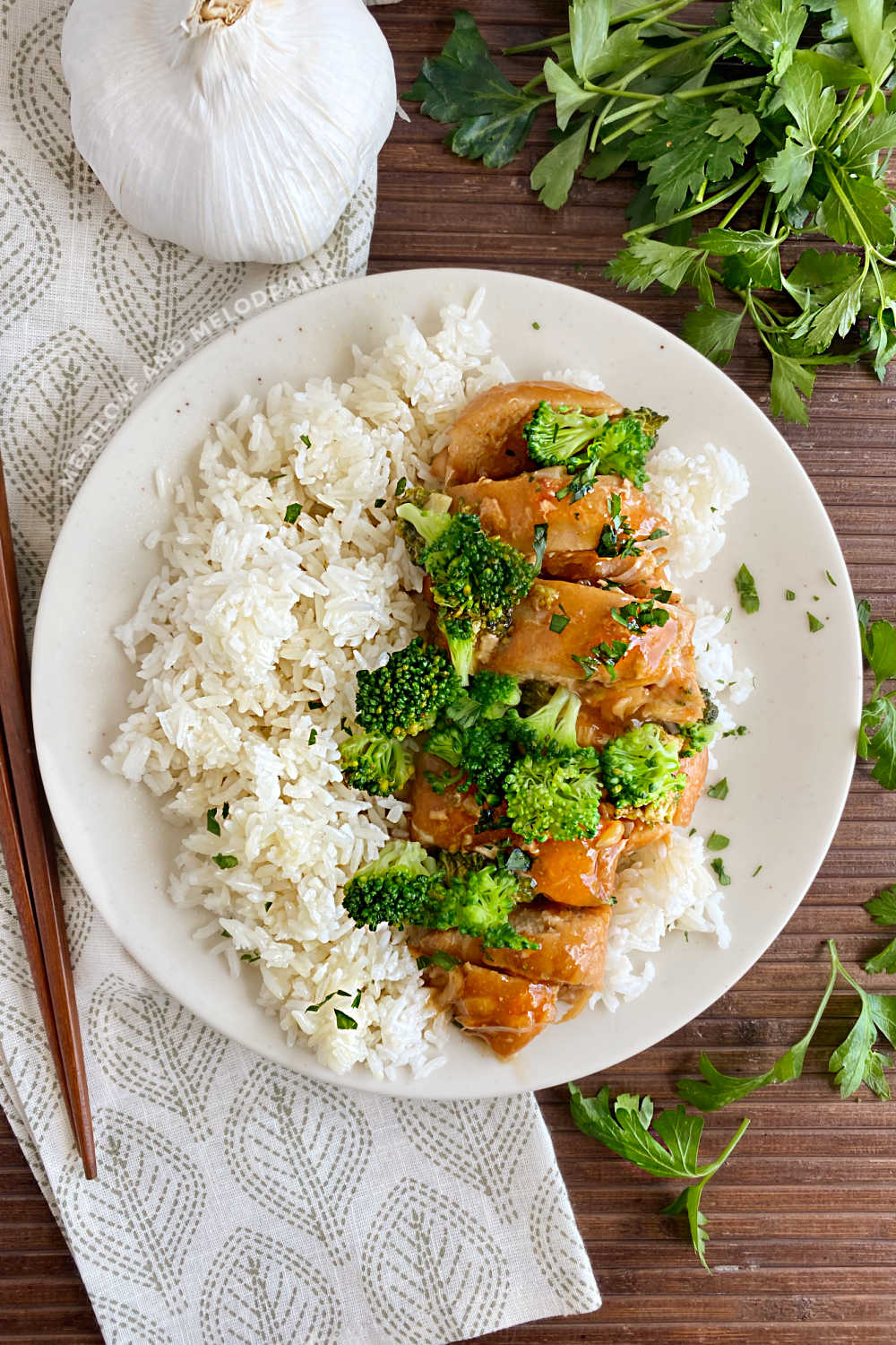 instant pot honey garlic chicken breasts with broccoli and rice on a plate with parsley