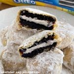 air fryer fried oreos coated in powdered sugar on a plate