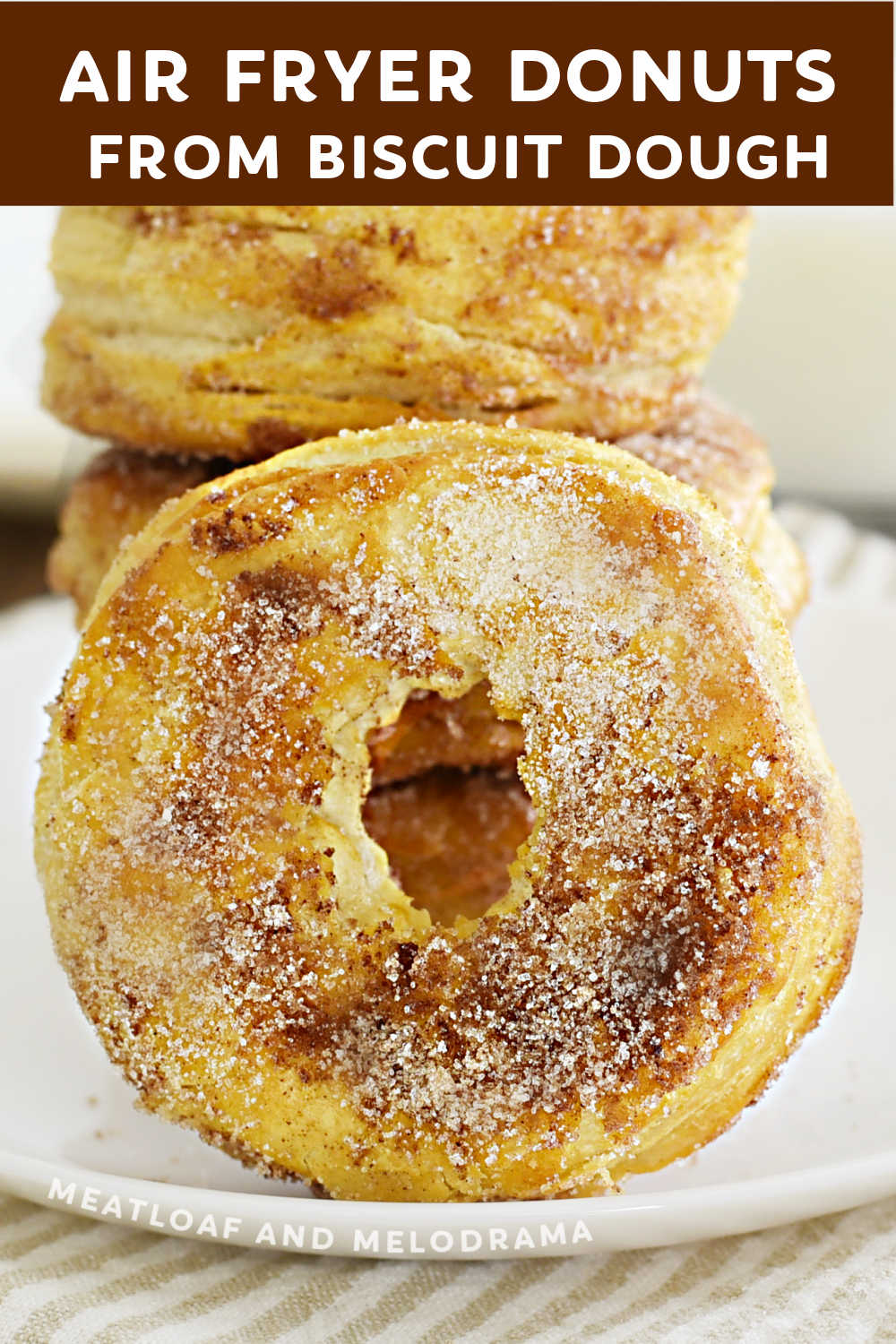 Easy Air Fryer Biscuit Donuts made with Pillsbury Grands canned biscuits and rolled in cinnamon sugar are ready in minutes! A quick and easy donut recipe for Instant air fryer, Ninja foodi or any basket or air fryer oven. via @meamel