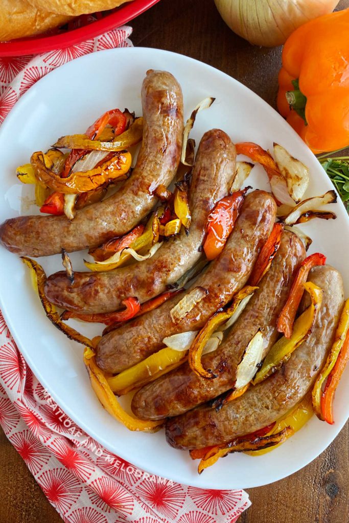 air fryer italian sausages with peppers and onions on a tray