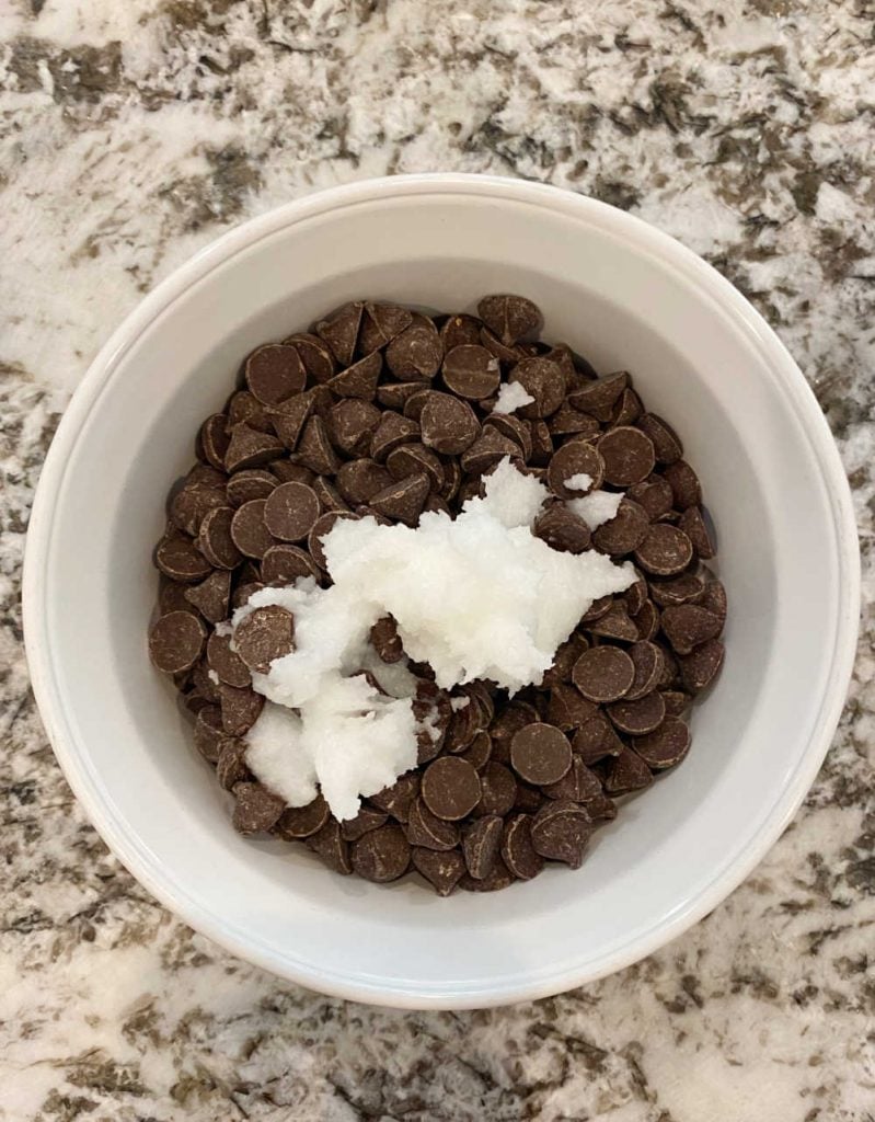 coconut oil and chocolate chips in a white bowl