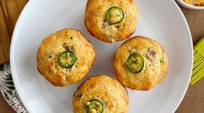 plate of jiffy jalapeno sausage cornbread muffins with jalapeno pepper slice on top