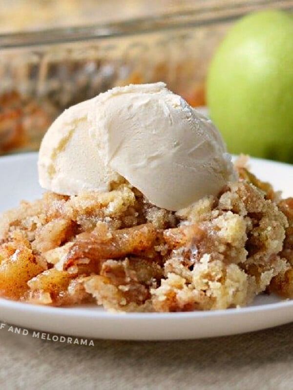 apple crisp without oats on a plate with vanilla ice cream on top
