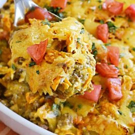 dorito casserole with tomatoes on a serving spooon