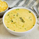 bowl of instant pot broccoli cheddar cheese soup on the table