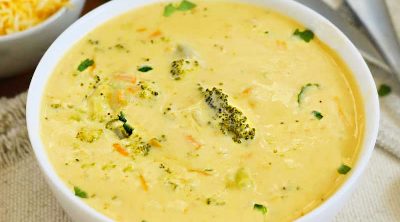 bowl of instant pot broccoli cheddar cheese soup on the table
