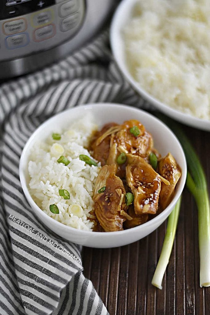 bowl of teriyaki chicken with jasmine rice and scallions